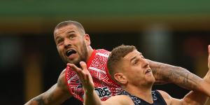 Lance Franklin battles Jacob Weitering of the Blues for possession. 