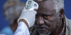 A man at the Zewditu Memorial Hospital in the Ethiopian capital of Addis Ababa has his temperature checked.