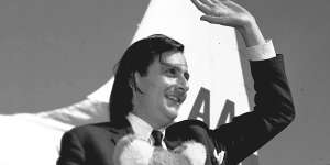 Barry Humphries with koala and Qantas bag arrives in Melbourne in 1965.