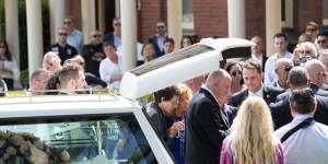 Bridget Sakr (centre in blue),the mother of 11-year-old Veronique Sakr who was killed by an alleged drunk driver,is supported by mourners as she arrives at her daughter's funeral at Santa Sabina College Chapel in Strathfield.
