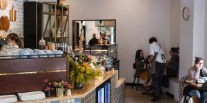 The Bells Road Social's counter features a patchwork of tiles and a display of chopping boards.