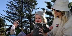 Belinda Melmoth (left) with her baby Ivy and Kelsie and baby Olive (right) with friends at a mothers group celebrating a birthday at North Wollongong beach.