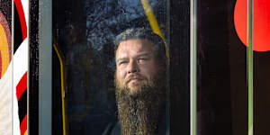 “I love taking it out here and putting it on the streets”:Tiriki Onus,inside the new art tram reproducing his father’s 1991 original work. 