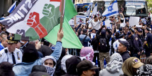 Supporters of Israel and Palestine gather at the Israeli consulate in New York on Monday.