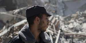 A Palestinian policeman stands in the rubble of a building destroyed by an Israeli airstrike that housed The Associated Press’ offices in Gaza City,Saturday,May 15,2021. 