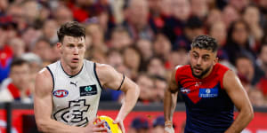 Carlton’s Sam Walsh bursts away from Melbourne’s Christian Salem on Friday night