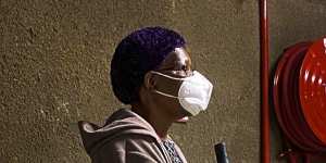 A woman waits to be tested for COVID-19 in a shopping centre car park in Johannesburg.