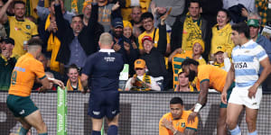 Len Ikitau holds his shoulder after scoring a try against Argentina at CommBank Stadium last month.