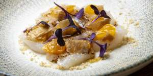 The go-to dish:raw scallops with black garlic,mandarin and chicken skin.