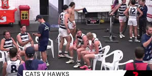 The Channel Seven cameras captured Tom Hawkins looking at a phone in the rooms during the weather break in Monday’s game.