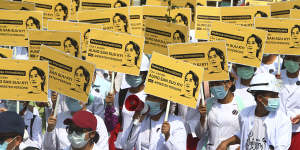 Medicals students display images of deposed Myanmar leader Aung San Suu Kyi during a street march in Mandalay,Myanmar.
