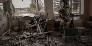 A Ukrainian serviceman stands in a heavily damaged building in Stoyanka,Ukraine,Sunday,March 27,2022. Ukrainian President Volodymyr Zelenskyy accused the West of lacking courage as his country fights to stave off Russia's invading troops,making an exasperated plea for fighter jets and tanks to sustain a defense in a conflict that has ground into a war of attrition. (AP Photo/Vadim Ghirda)