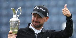 ‘I get out here and it’s armageddon’:Harman soaks up pressure in rain to win British Open