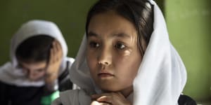 Behishta,11,listens during 4th grade class at the Zarghoona high school for girls in Kabul. There is widespread fear the Taliban will reintroduce its notorious system barring girls and women from almost all work,and access to education. 