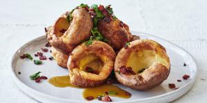 Popover yorkies with sizzling bacon and maple syup.