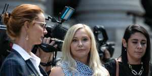 Virginia Giuffre (centre) leaves the Federal Court in New York on August 27,2019.