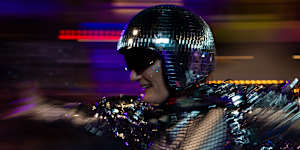 A human disco ball flies through the crowd.