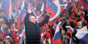 Russian President Vladimir Putin appears at a pro-war rally in Moscow.