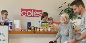 “People were talking about what was going on in our little house in Forresters Beach on a global scale”:Jason Genderen takes his mother shopping at a supermarket he set up in his home.