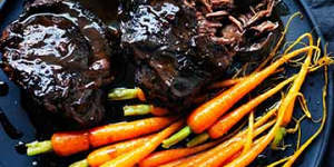 Braised beef cheeks with baby carrots.
