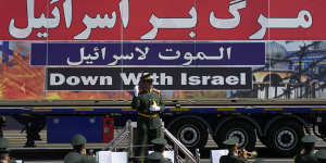 An anti-Israel banner is carried on a truck in an annual military parade in September in front of the shrine of the late revolutionary founder Ayatollah Khomeini,just outside Tehran,Iran.