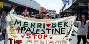 Protesters in Coburg outside the office of Labor MP Peter Khalil,with a banner featuring the red inverted triangle associated with Hamas.