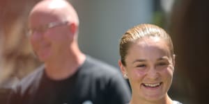 Ash Barty,with coach Craig Tyzzer in the background,speaks to the media in Brisbane on Thursday.