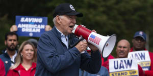 FILE - President Joe Biden speaks to striking United Auto Workers on the picket line in Michigan last year. 