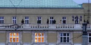 Police officers stand on the balcony of Philosophical Faculty of Charles University in downtown Prague.