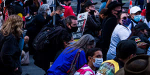 This afternoon in Sydney,hundreds marched against the injustices of over 400 indigenous Australian deaths whilst in custody throughout Australia. This evening was also in solidarity with those across America who have take to the streets across the states,seeking justice for George Floyd,who last week died at the hands of Minneapolis police officers. Sydney Town Hall. Saturday 6th June 2020. Photograph James Brickwood. SMH NEW 200606 Coronavirus COVID-19