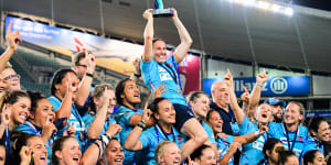 Ash Hewson holds up the inaugural Super W trophy in 2018.
