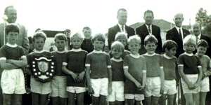 A young Arnold (second from left) with a trophy and his Under 7 Gwawley Bay team.