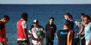 Eddie Jones explains a drill to his Wallabies forwards on Coogee Beach this week.