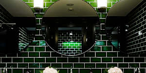 Restaurant bathrooms can be an unexpected pleasure,easily applied to powder rooms at home. Go for bold with striking colours. Fragrant flowers don’t hurt either. 