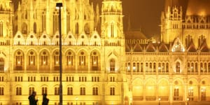 Romantic spot:A couple in front of parliament building,Budapest,Hungary.