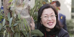 Liberal MP Gladys Liu poses with a koala during an event to mark National Threatened Species Day on Tuesday.