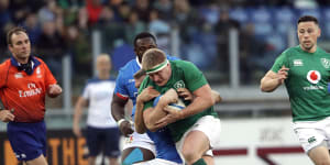 Tough grind:Ireland's John Ryan hits the line during the 26-16 Six Nations victory over Italy in Rome.