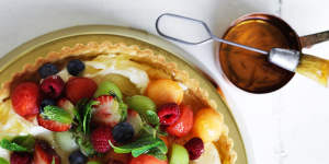 Melon and berry mascarpone tart with marmalade glaze.