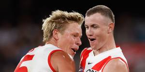 Chad Warner of the Swans celebrates a goal with teammate Isaac Heeney.