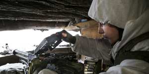 A serviceman checks his machinegun in a shelter on the territory controlled by pro-Russian militants in the Luhansk region of eastern Ukraine.