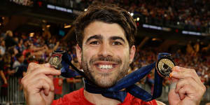 Christian Petracca after the 2021 grand final with his Norm Smith and premiership medals.