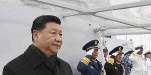 Chinese President Xi Jinping reviews a naval parade.