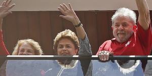Brazil's former president Luiz Inacio Lula da Silva,right,with President Dilma Rousseff,centre,and Lula's wife,Marisa Leticia,left,wave to supporters from the balcony of his home on Saturday.
