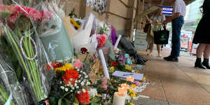 People lay flowers for Tia Cameron,who was killed in a bus in Brisbane’s CBD crash on Friday.