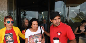 Leetona Dungay (centre) is supported at the NSW Coroners Court on Friday.