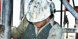 A worker repairs drilling pipes on a site in the Cooper Basin region in South Australia.