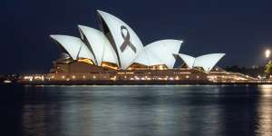 A black ribbon is projected on the Sydney Opera House.