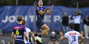 Ryan Papenhuyzen leaps high for the ball.