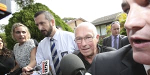Detectives take Roger Rogerson (centre) from his home in Padstow Heights in 2014.