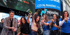 Coinbase employees celebrate during the company’s initial public offering outside the Nasdaq MarketSite in New York.